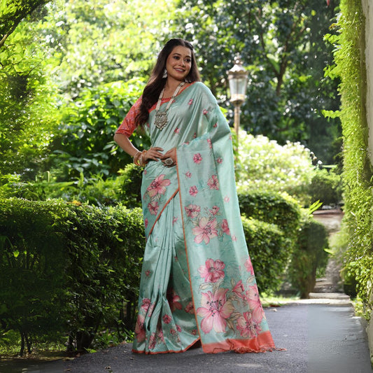 Woman wearing pastel sea green floral print saree posing outdoors in elegant traditional Indian
