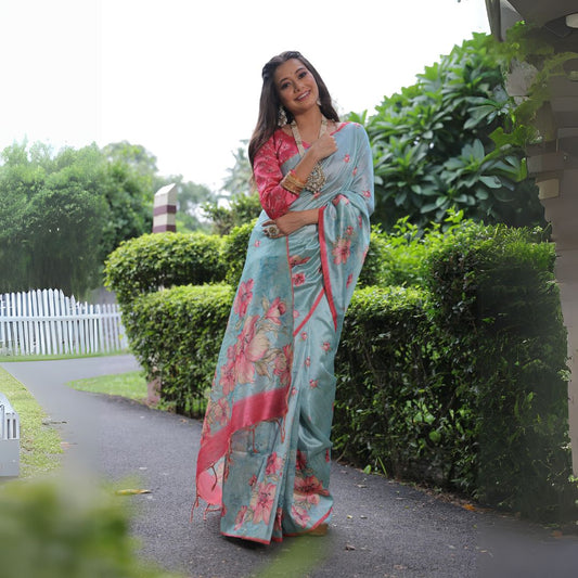 Woman wearing powder blue floral print saree posing outdoors in elegant traditional Indian ethnic outfit