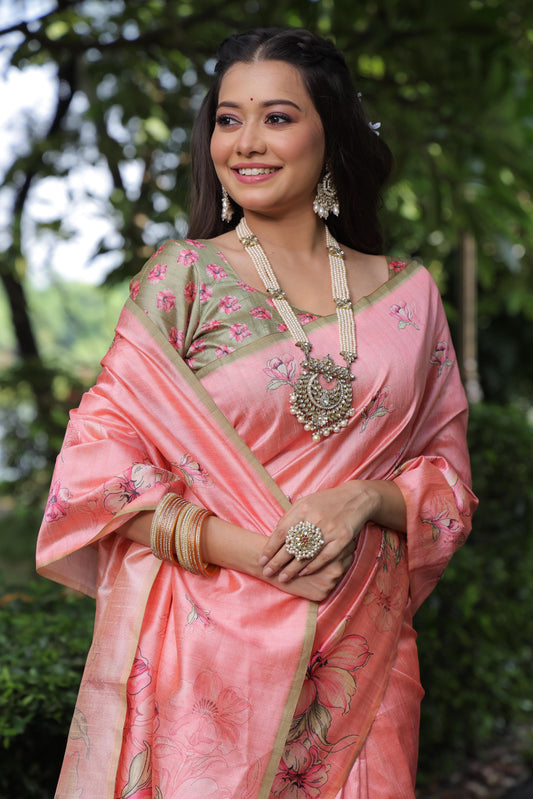 Woman wearing tulip pink floral print saree standing outdoors in traditional Indian ethnic outfit