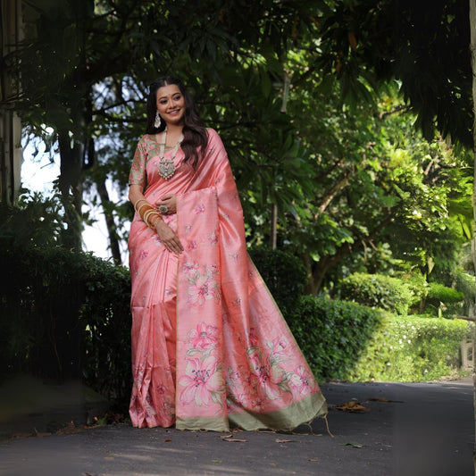 Woman wearing tulip pink floral print saree standing outdoors in traditional Indian ethnic outfit
