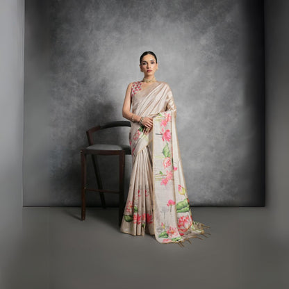 Woman wearing light beige floral printed saree posing outdoors in traditional Indian ethnic attire