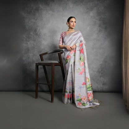 Woman wearing light gray floral printed saree posing outdoors in traditional Indian ethnic attire