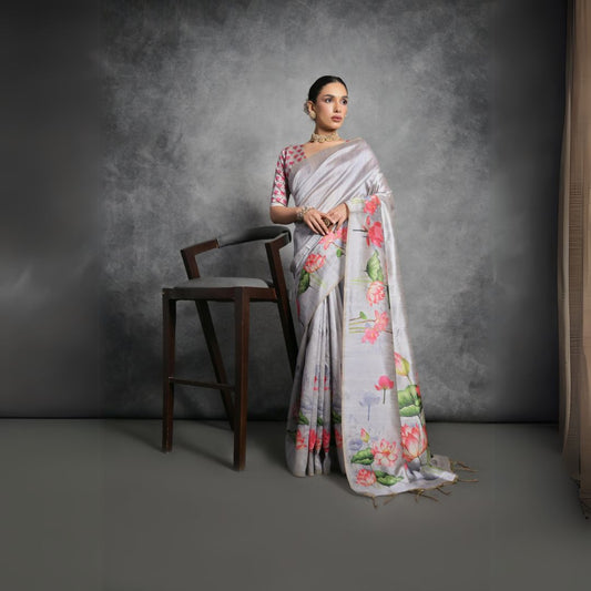 Woman wearing light gray floral printed saree posing outdoors in traditional Indian ethnic attire
