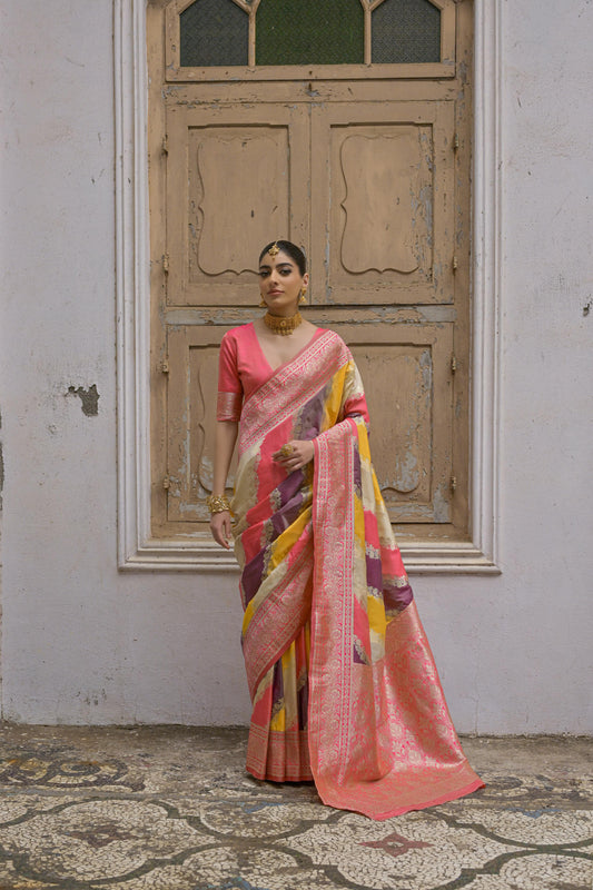 A woman wearing a tulip pink floral printed saree, standing outdoors in elegant traditional Indian ethni
