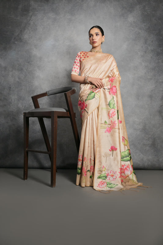 Woman wearing yellowish beige floral printed saree standing outdoors in elegant traditional Indian ethnic attire