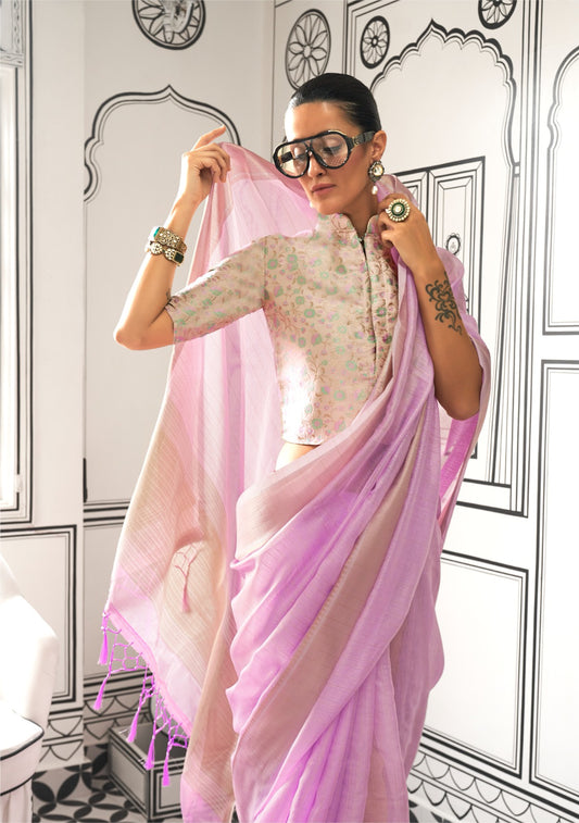 Woman in a lavender zari work saree adjusting her pallu in a room with black-and-white architectural wall illustrations