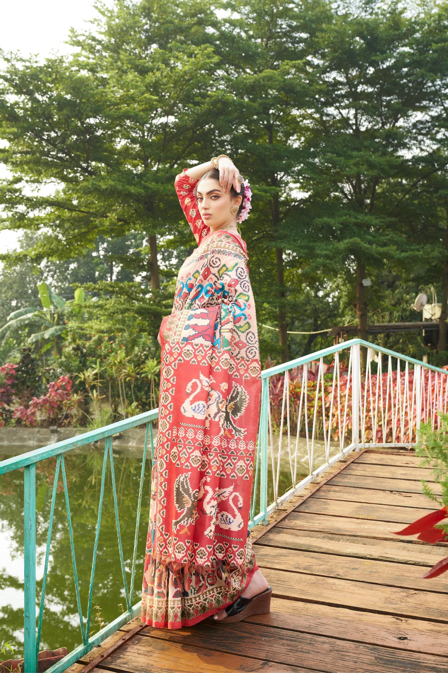 Light beige saree with Patola print on a bridge outdoors