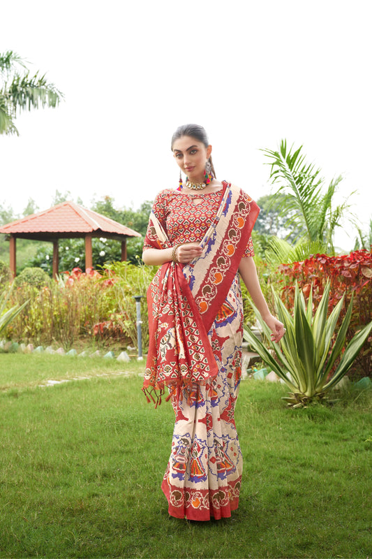 Light beige saree with Patola print and red border outdoors