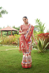 Light beige saree with Patola print and red border outdoors