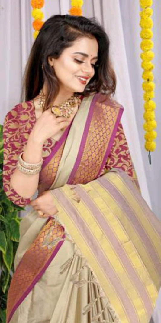 Light beige silk saree with magenta gold zari border paired with maroon brocade designer blouse yellow striped pallu traditional wedding wear kundan jewelry festive backdrop