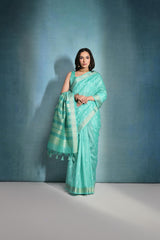 Light teal saree featuring intricate ikkat and zari weaving, showcasing traditional handloom textile craftsmanship