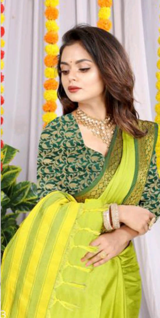 woman in lime green silk saree with rich zari border and matching green blouse for festive wear
