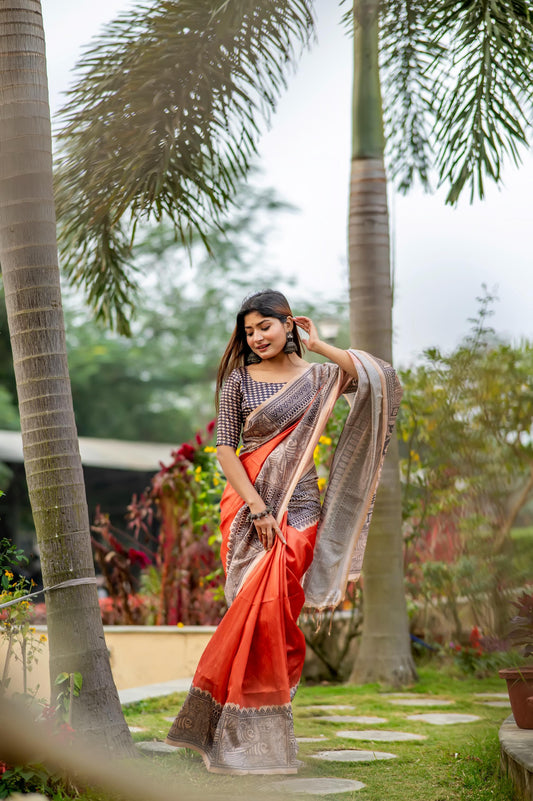 Woman wearing dark pastel red Madhubani print saree standing outdoors in traditional Indian ethnic attire