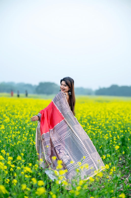 Woman wearing red Madhubani print saree posing outdoors in traditional Indian ethnic wear