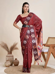 Woman wearing a maroon Banarasi silk saree with intricate floral motifs and a contrasting copper border, paired with a matching blouse and statement pearl necklace, elegantly posing beside a wooden chair in a minimalist studio setting with neutral decor, ceramic vases, and pampas grass.

Related
maroon-banarasi-silk-saree-floral-border-modern-studio
Woman in a maroon Banarasi silk saree with floral motifs and gold border, posing in a minimalist studio setting.