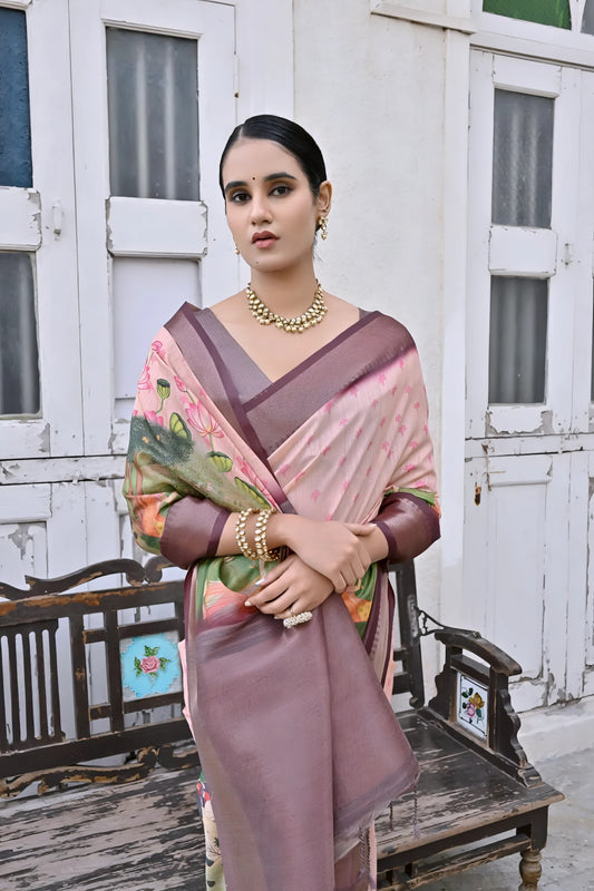 Woman wearing a mauve floral silk saree with a contrasting border and traditional jewelry, elegantly standing beside a vintage wooden bench in front of classic white arched doors and windows, with greenery on the side in a heritage courtyard setting.