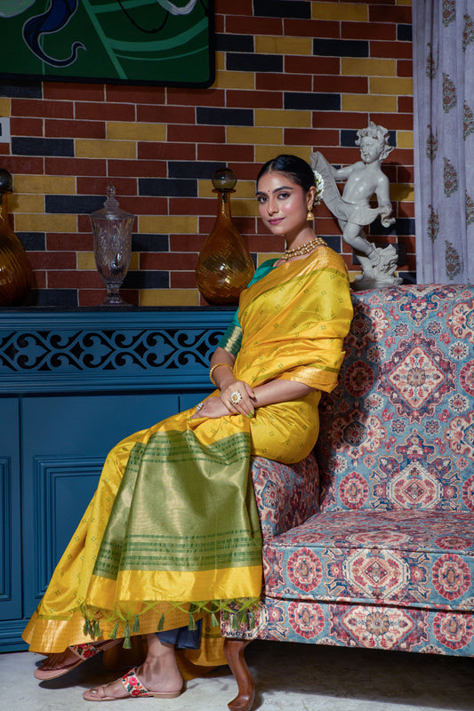 Mustard yellow saree with zari work and green border sitting