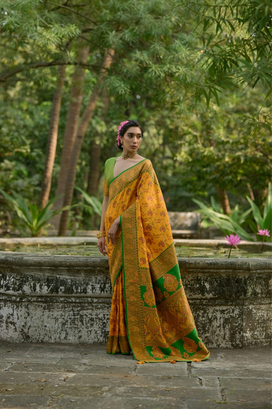 Mustard yellow soft pashmina silk saree with intricate zari work, perfect for festive and ceremonial occasions.