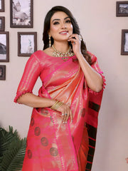 Woman wearing a pink saree with a gold blouse, posing indoors.