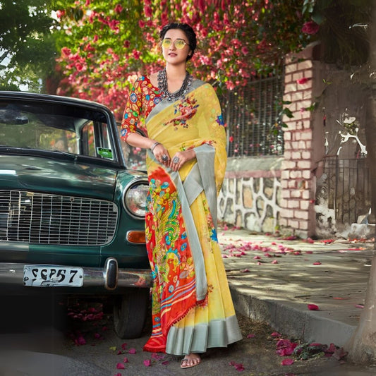 Woman in a pale yellow floral print saree standing beside a vintage car with scattered petals and colorful flowers in the background