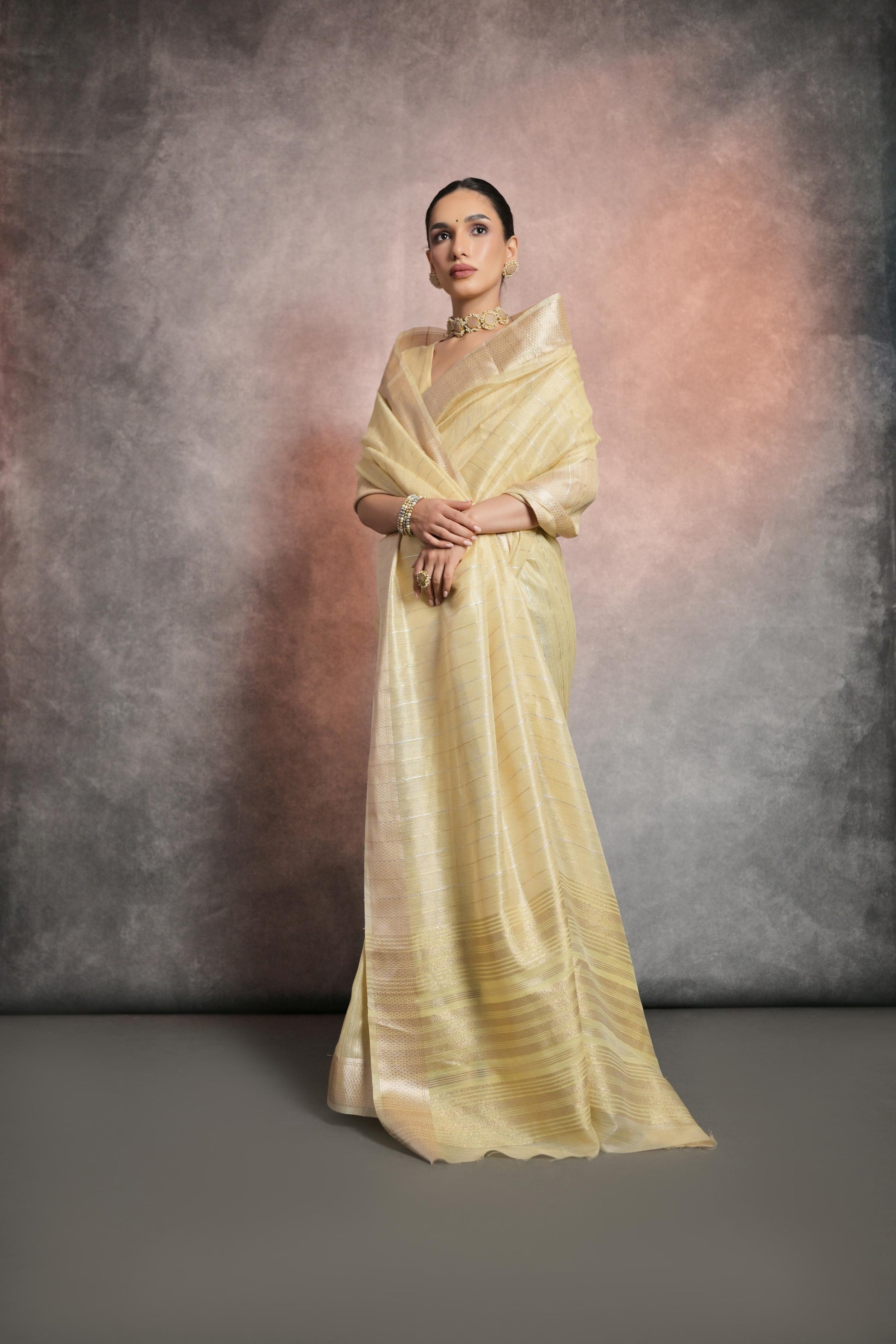 Elegant pale yellow saree made from soft and lustrous rangoli silk fabric