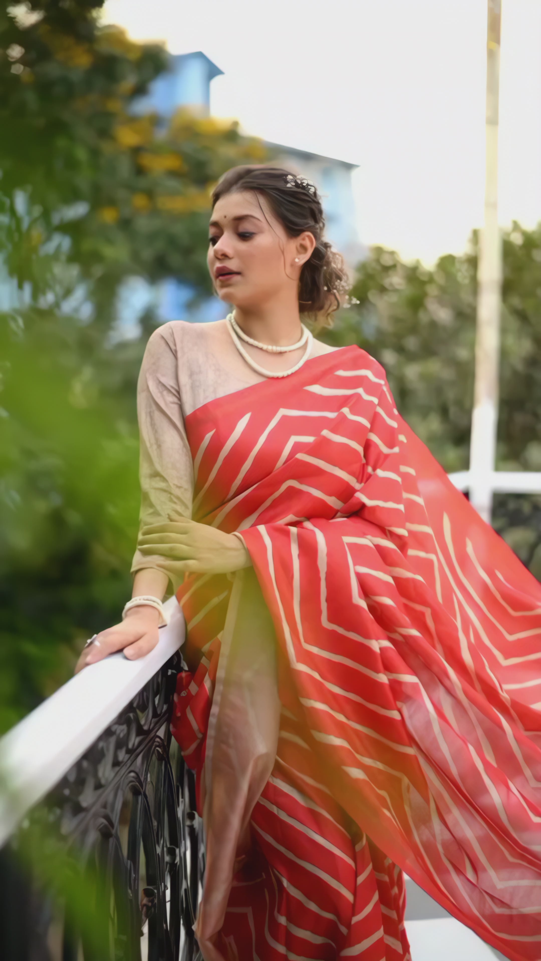 woman-geometric-silk-saree-floral-embroidered-pallu-pearl-jewelry-modern-cafe