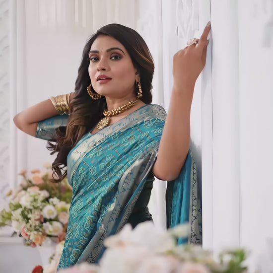 teal-silk-saree-silver-border-floral-white-room