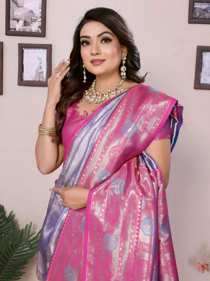Woman wearing a pink saree with a pattern, posing indoors.