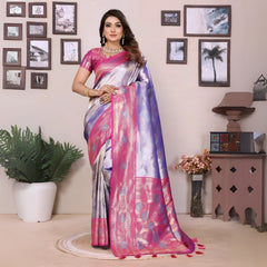 Woman in a pink and silver saree standing in a room with decorative elements.