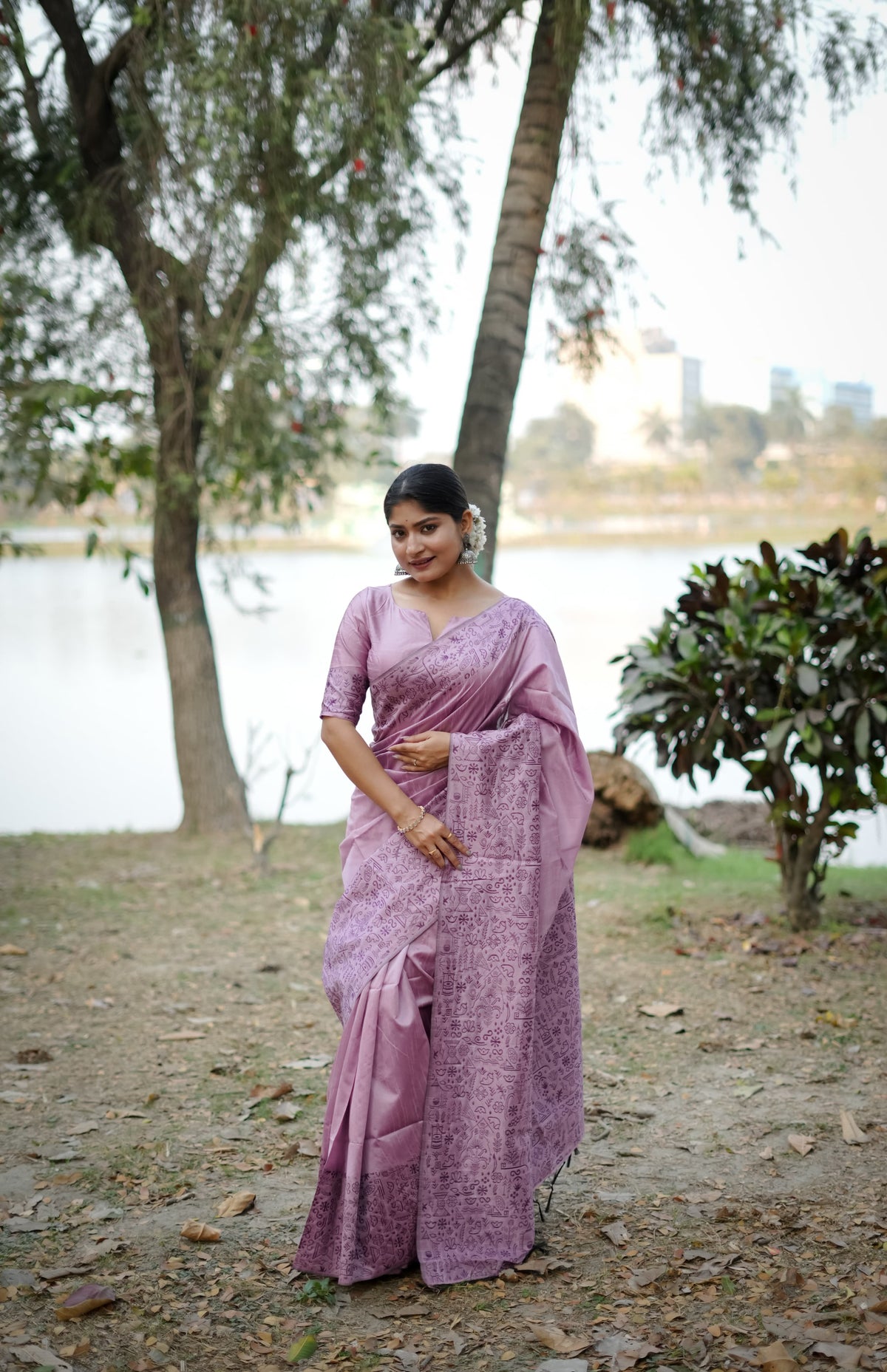 Purple saree with zari work in an outdoor setting