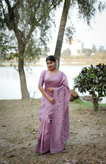 Purple saree with zari work in an outdoor setting