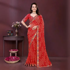 Woman wearing a red bandhani print saree with a contrast patterned border and matching blouse, styled with a choker necklace in an indoor studio setup, Indian ethnic wear product photo