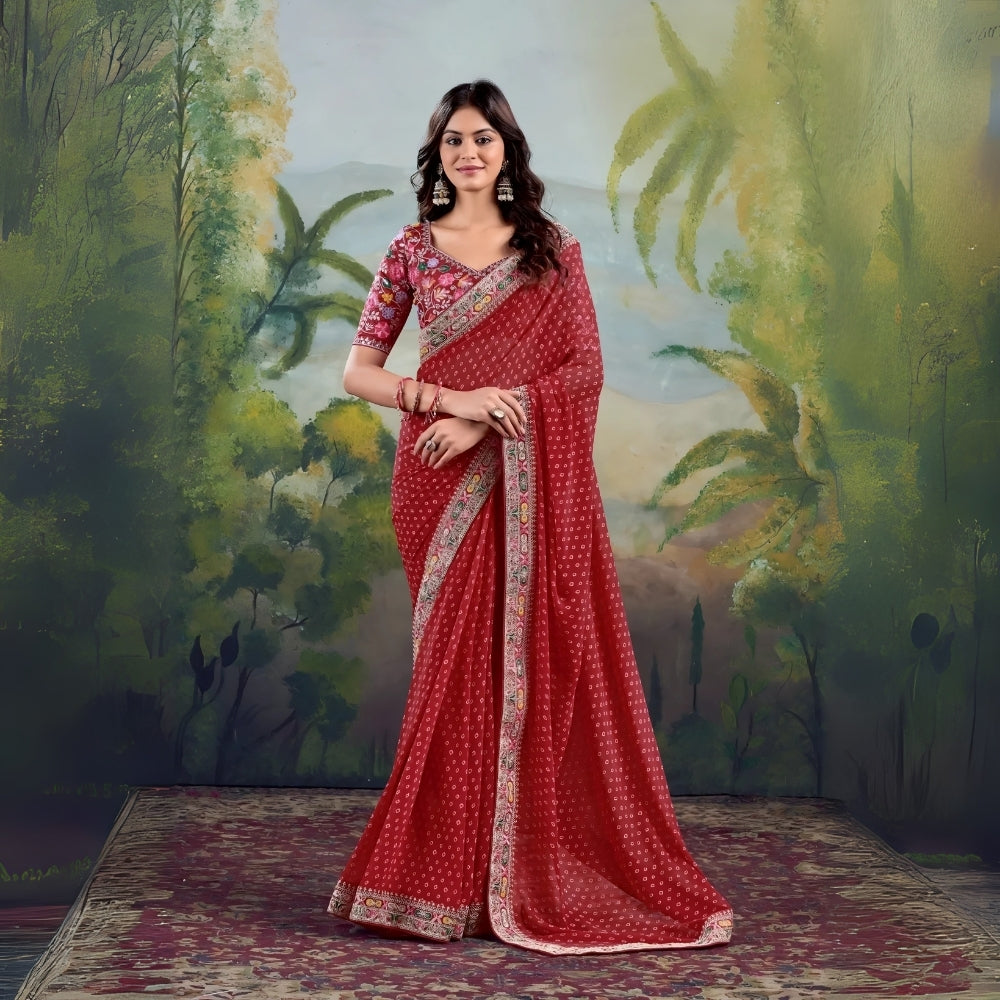 Woman wearing red saree with floral embroidered border and matching blouse in studio backdrop