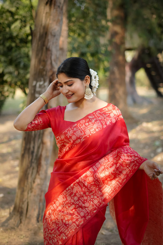 Red saree with intricate zari work close up
