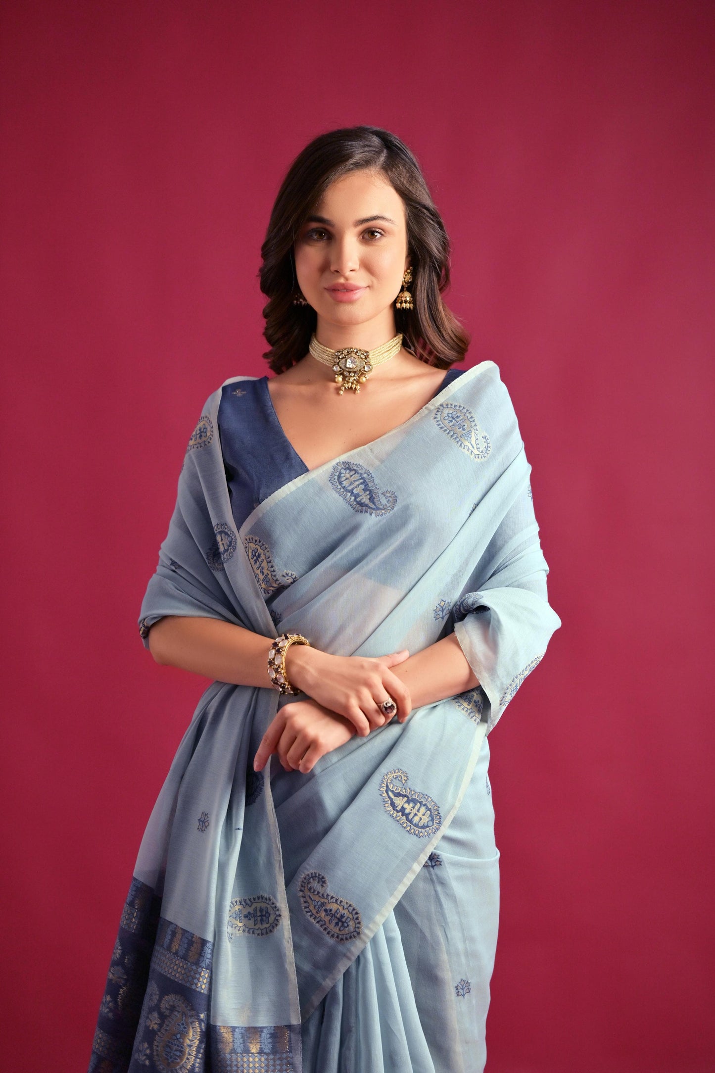 Woman wearing blue gray Resham weaving saree posing outdoors in traditional Indian ethnic attire