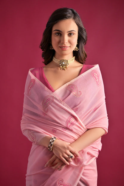 Woman wearing pink Resham weaving saree standing outdoors in elegant traditional Indian ethnic