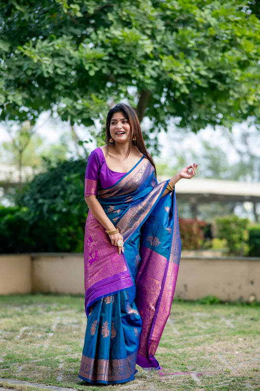 Woman wearing teal blue saree with zari work posing outdoors in traditional Indian attire