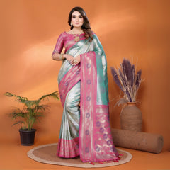 Woman in a pink and gray saree standing against an orange background with decorative elements.