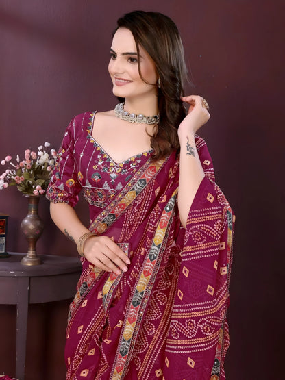Woman wearing a wine color digital print saree with embroidery work and a contrast patterned border, paired with a matching blouse in an indoor studio product image, Indian ethnic wear