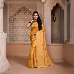 Woman wearing a mustard yellow silk saree with subtle geometric patterns and traditional jewelry, standing in a heritage-inspired room with ornate carved arches and lattice window