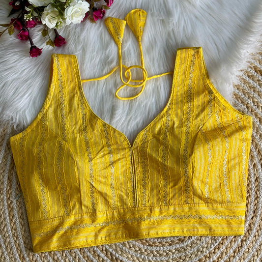 Elegant Yellow Zari Work Blouse Top crafted from silk fabric, featuring intricate embroidery patterns, perfect for festive and traditional occasions.