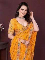 Woman wearing a yellow digital print saree with embroidery work and a contrast patterned border, paired with a matching blouse in an indoor studio product image