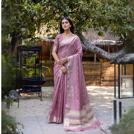 Woman wearing lavender pink Zari weaving saree posing outdoors in elegant traditional Indian attire