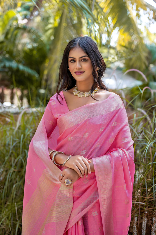 Woman wearing light pink Zari weaving saree standing outdoors in traditional Indian ethnic