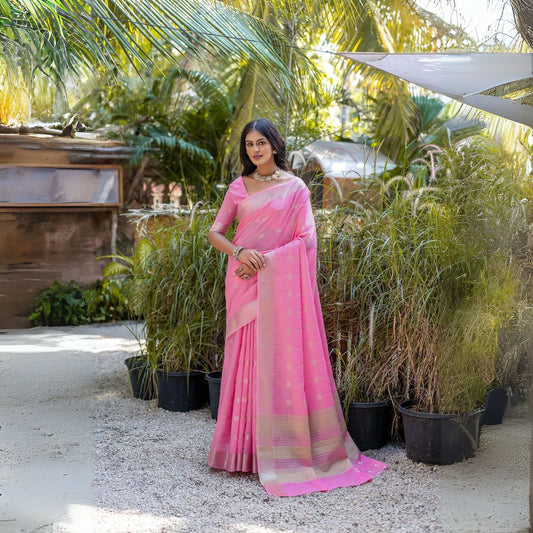 Woman wearing light pink Zari weaving saree standing outdoors in traditional Indian ethnic attire