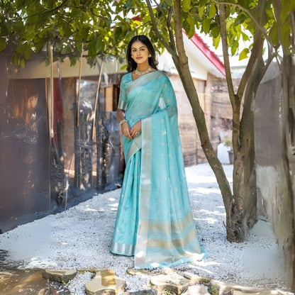 Woman wearing powder blue Zari weaving saree posing outdoors in traditional Indian ethnic attire