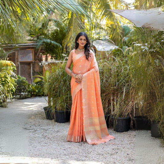 Woman wearing soft peach Zari weaving saree standing outdoors in traditional Indian ethnic outfit