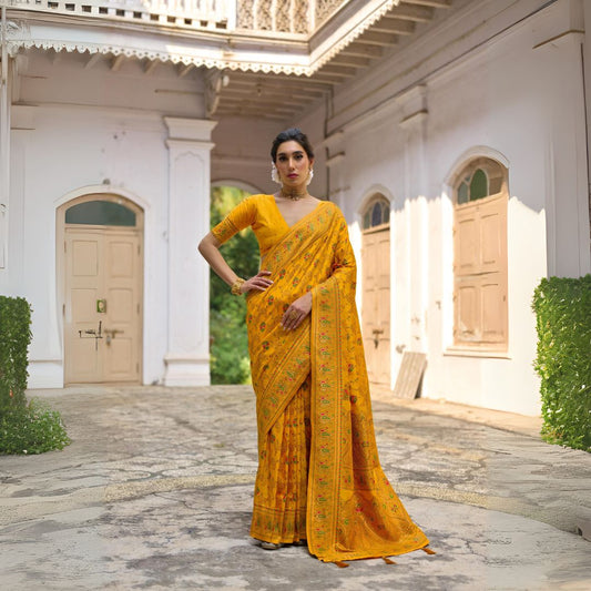 Woman wearing brown yellow Zari work saree standing outdoors in traditional Indian ethnic attire